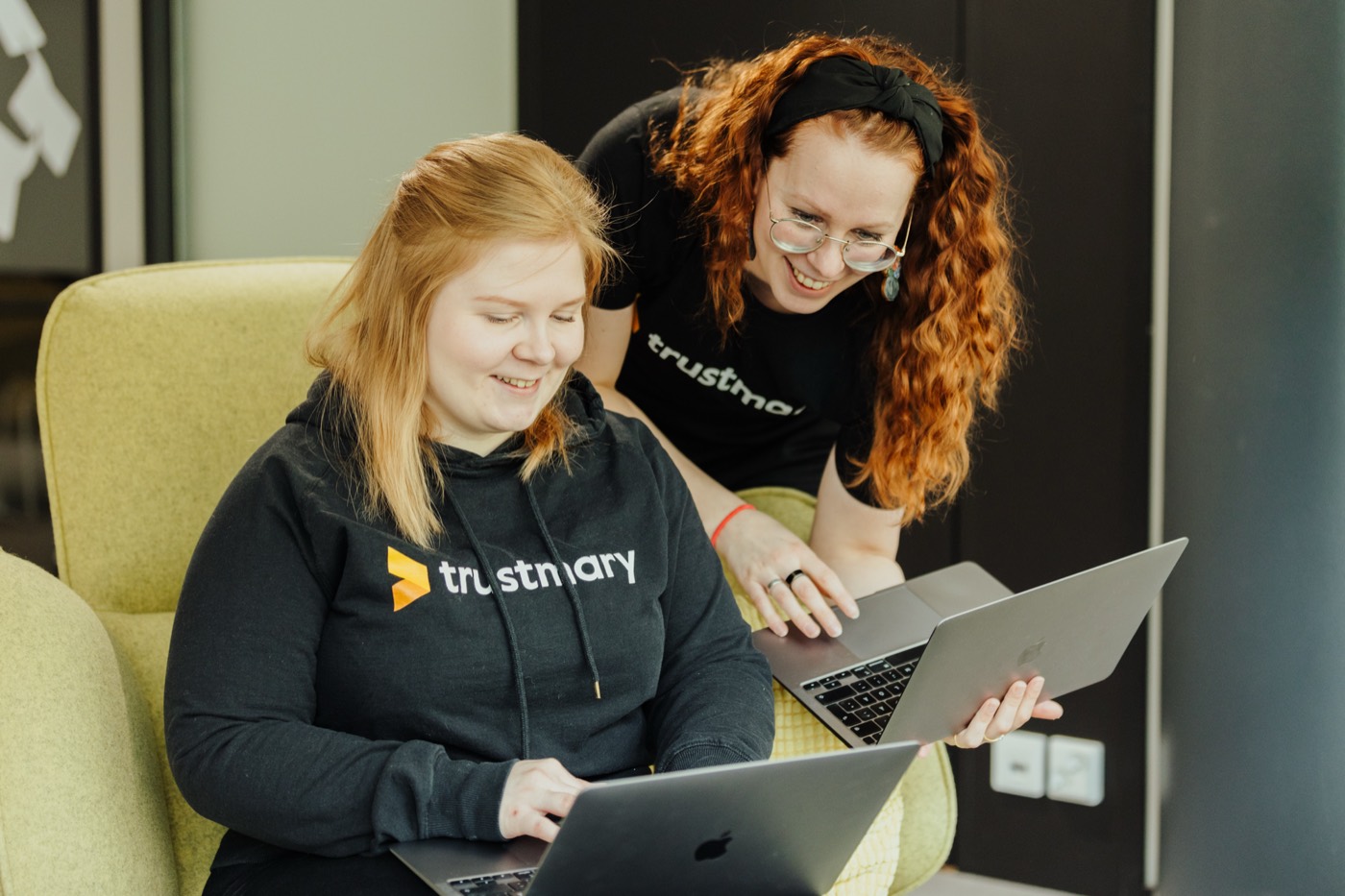 Two Trustmary colleagues working on a laptop